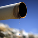 A dry pipe drips water on Gless Ranch in Kern County, California.